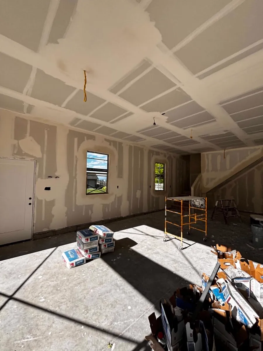Bright open room with freshly hung and taped drywall on a Toro R Services project in Cache Valley, Utah
