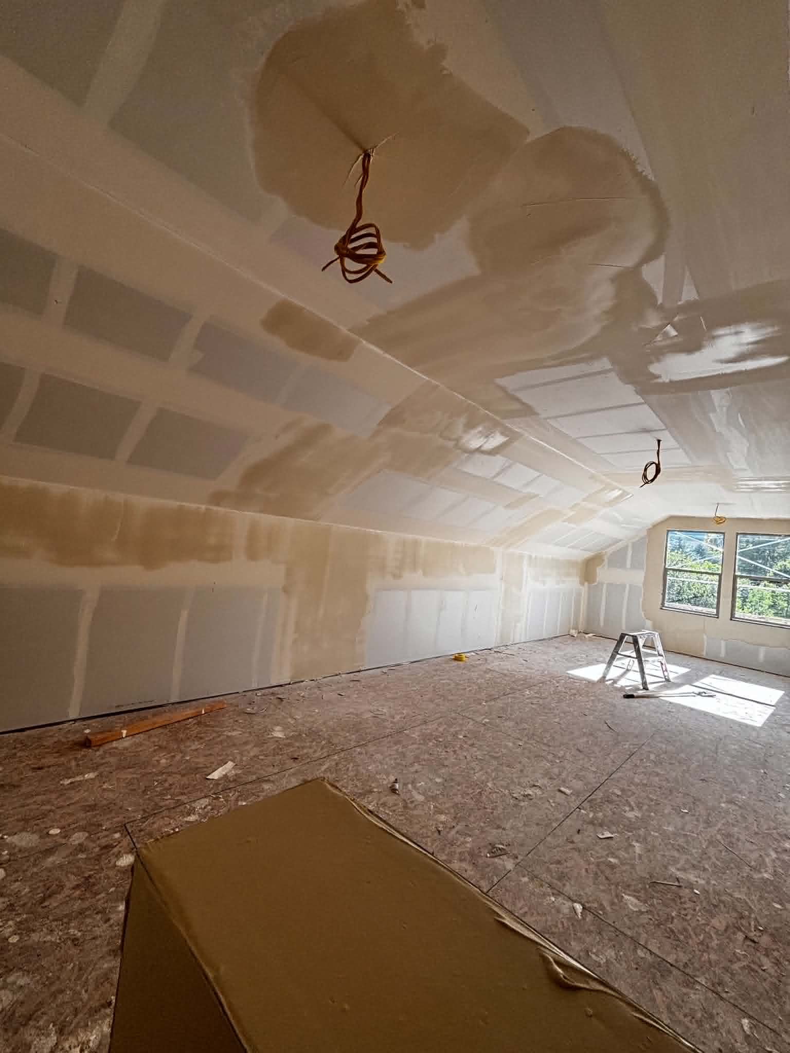 Drywall taping and mudding in progress on a vaulted ceiling by Toro R Services in Logan, Utah