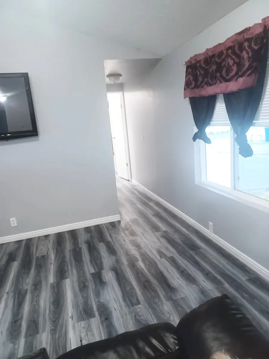 Finished living room with painted walls and new flooring in Logan, Utah