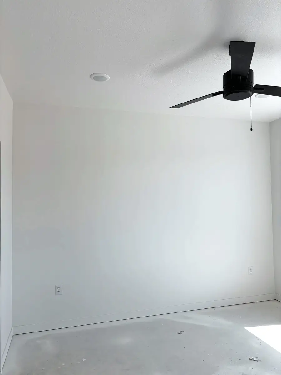 Bright finished room with smooth painted walls and a ceiling fan in Logan, Utah